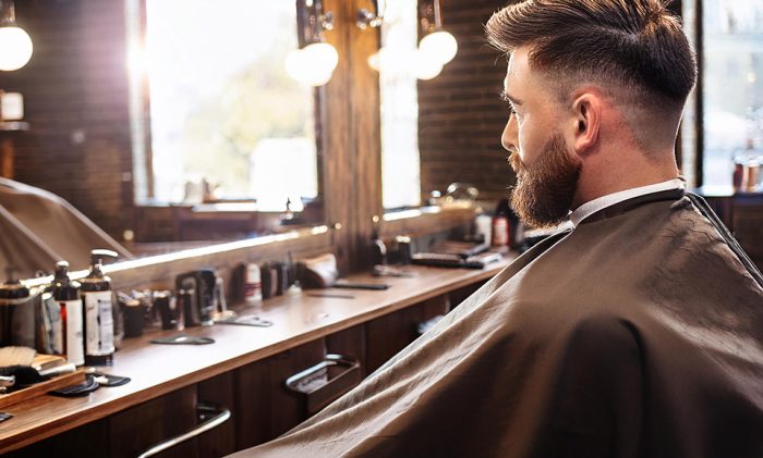 man sitting in barbers chair putney